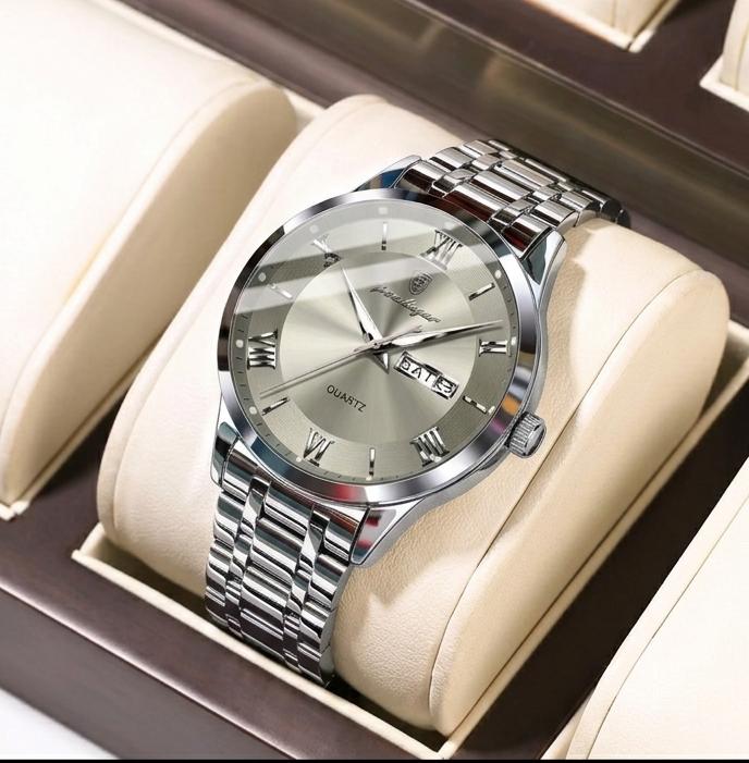 Silver wristwatch with a beige cushion in a display box