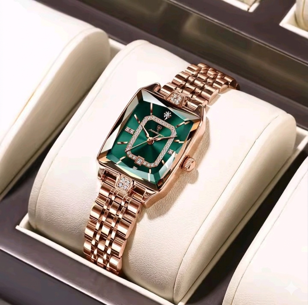 Luxury watch with rose gold strap and green face in a display case